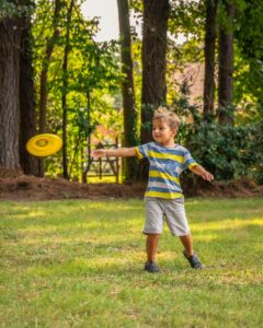 Boy playing with frisbee in Virginia yard